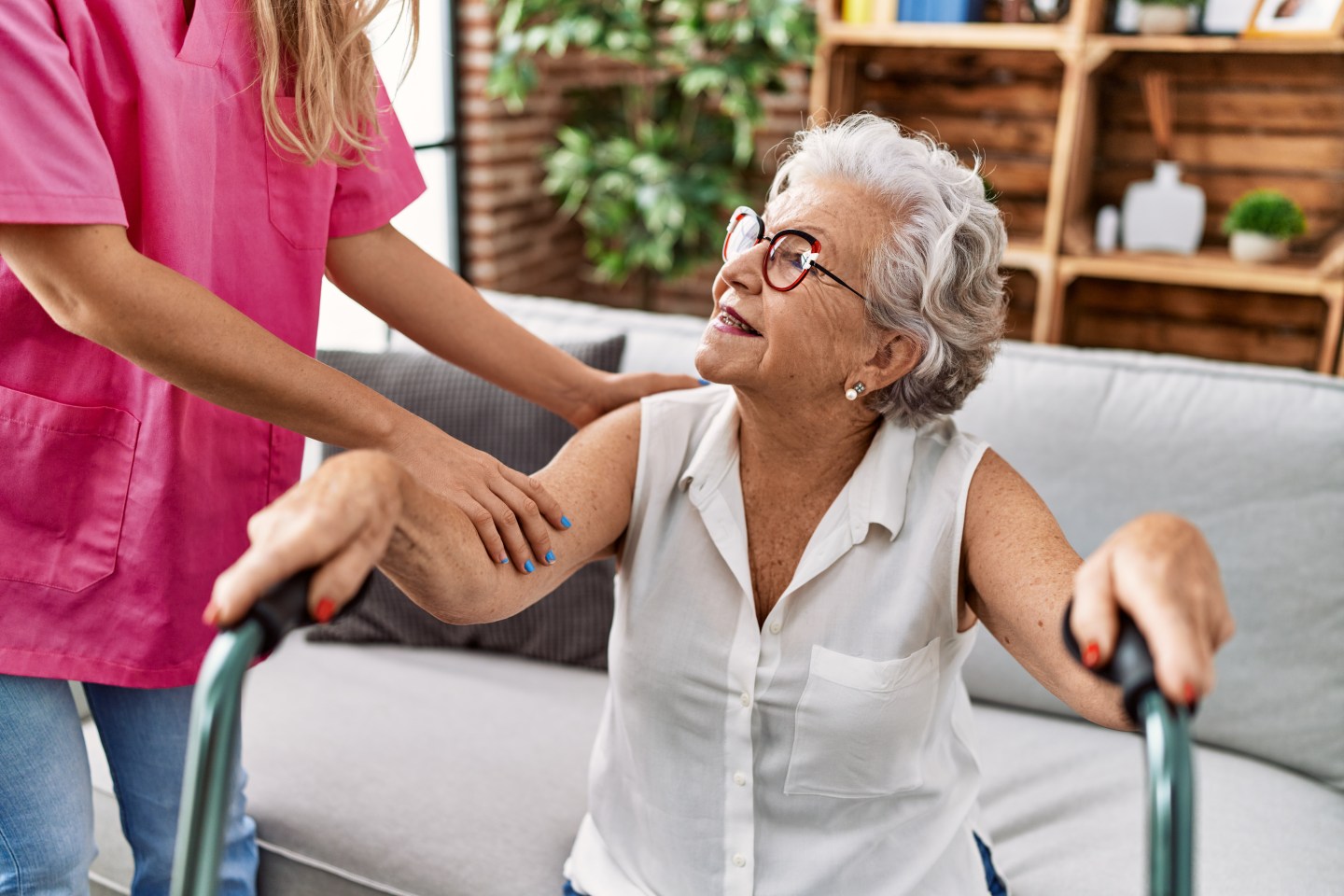 A caregiver warmly supporting a senior at home